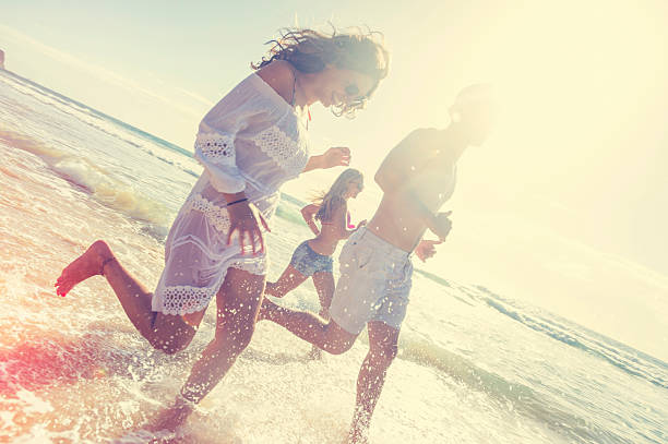 istock Smiling young people running on the beach 511811548