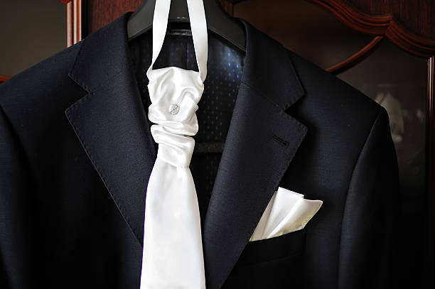 istock groom suit and white tie on a hanger 511811560