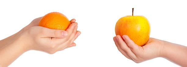istock Children's hands give Orange and yellow Apple 511813318