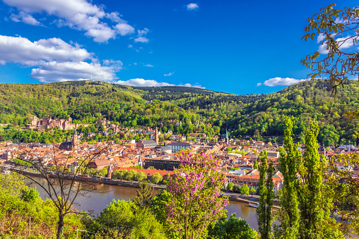 Elevated panoramic view on Heidelberg, the river Nekar and surrounding mountains in early spring.