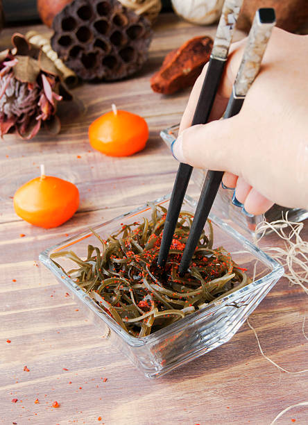 istock seaweed and chopsticks, on an open wooden table 511814032