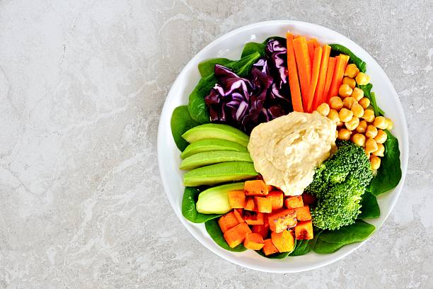 istock Lunch bowl with fresh vegetables and hummus on marble 511814294