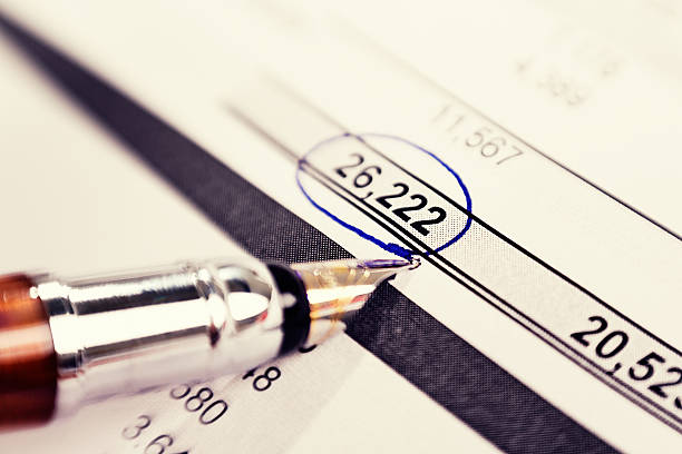 istock Pen nib circling figure on financial document 511845343