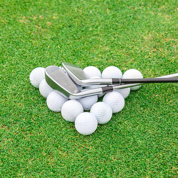 istock golf ball on tee in front of driver green course 511845971