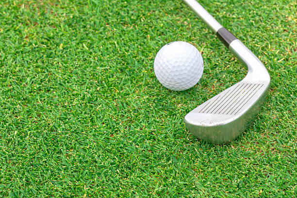 istock golf ball on tee in front of driver green course 511845977