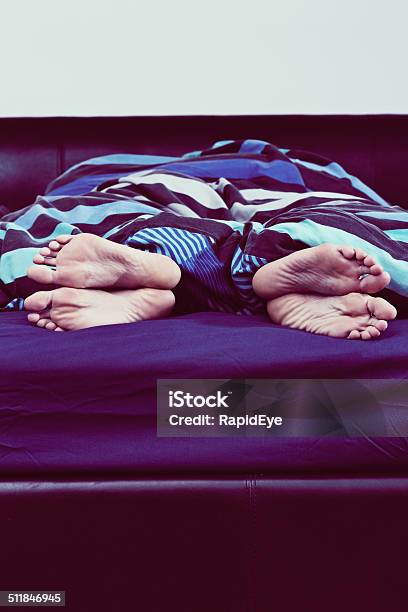 Relationship Trouble Feet Of Couple Turned Away From One Another Stock Photo - Download Image Now