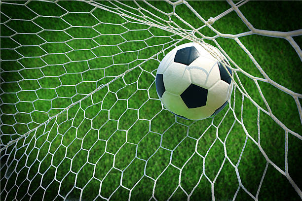 soccer ball in goal stock photo