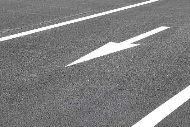 istock White traffic arrow signage  on an asphalt road 511848211