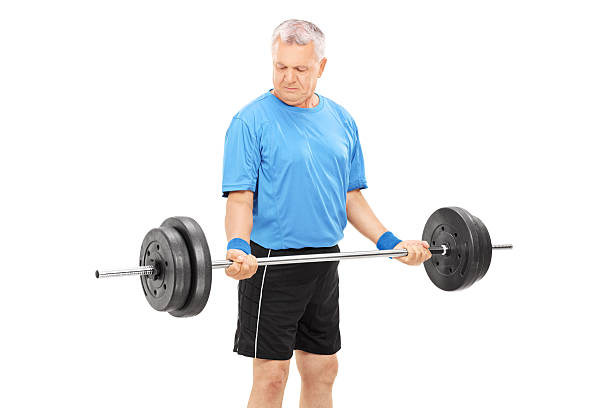 istock Mature man exercising with a heavy barbell 511848905