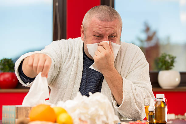istock Sick man suffering cold and winter flu virus drinking tea 511849710