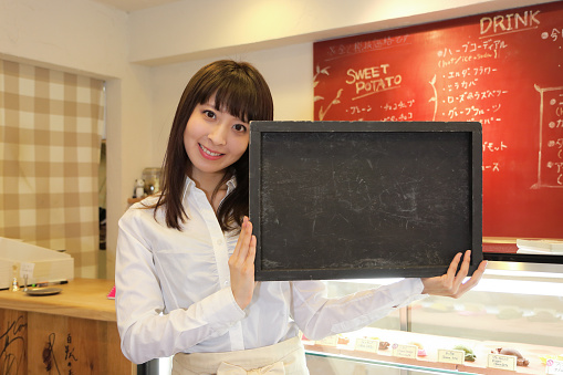 Waitress with  a daily offer blackboard.