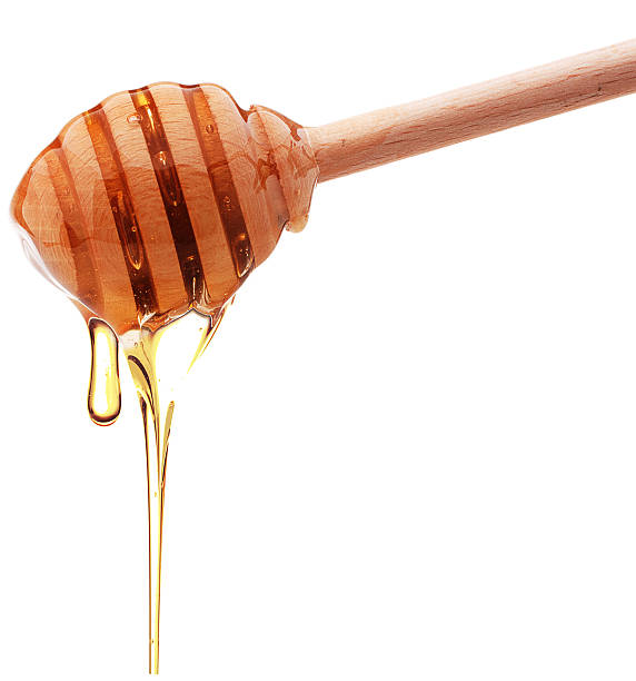 istock Honey dripping from a wooden honey dipper 511850322