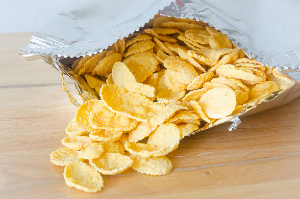 istock Cereal cornflakes in Aluminum foil package on wooden table 511850446