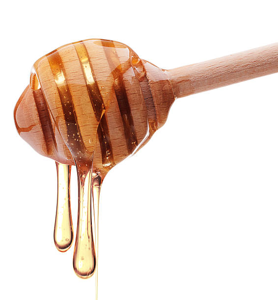istock Honey dripping from a wooden honey dipper 511850610