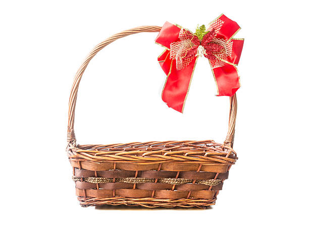 istock Wicker basket with a red ribbon isolated on white background 511851460