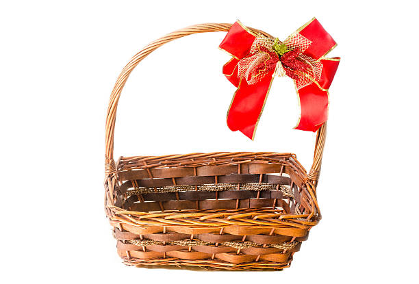 istock Wicker basket with a red ribbon isolated on white background 511851980