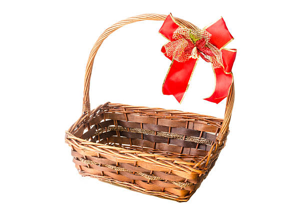 istock Wicker basket with a red ribbon isolated on white background 511852046