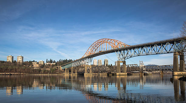 Pattullo Bridge and Railroad Track, New Westminster Pattullo Bridge and Railroad Track over the Fraser River between New Westminster and Surrey British Columbia new westminster stock pictures, royalty-free photos & images