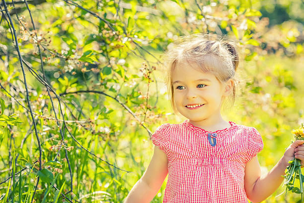 istock Happy little girl in spring sunny park 511852560