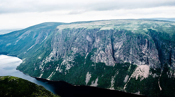 istock Large steep cliffs and plateau forming fjord under overcast sky 511854068