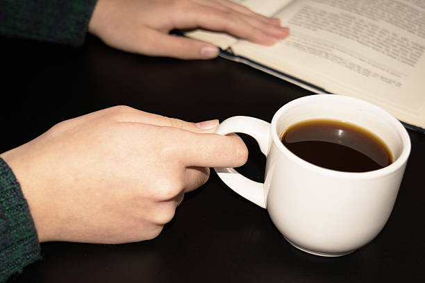 istock open book with a cup of coffee on wood table 511855146