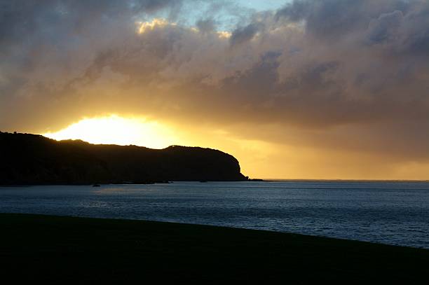 istock Sunset over land and sea 511857378