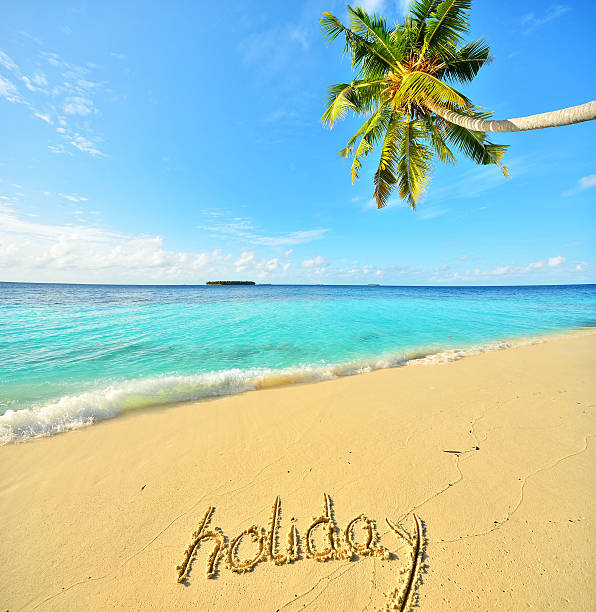 istock Holiday word written on the tropical beach 511858838