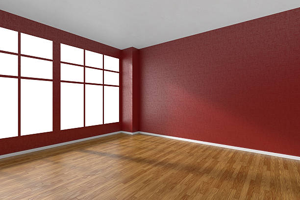 istock Empty room with parquet floor, textured red walls and window 511859534