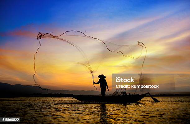 Silhouette Of Traditional Fishermen Throwing Net Fishing Stock Photo - Download Image Now
