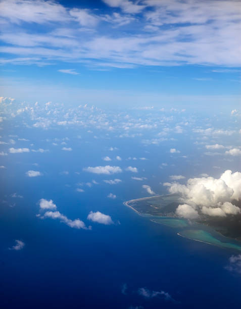 istock Polynesia. The atoll in ocean through clouds. Aerial view. 511862052