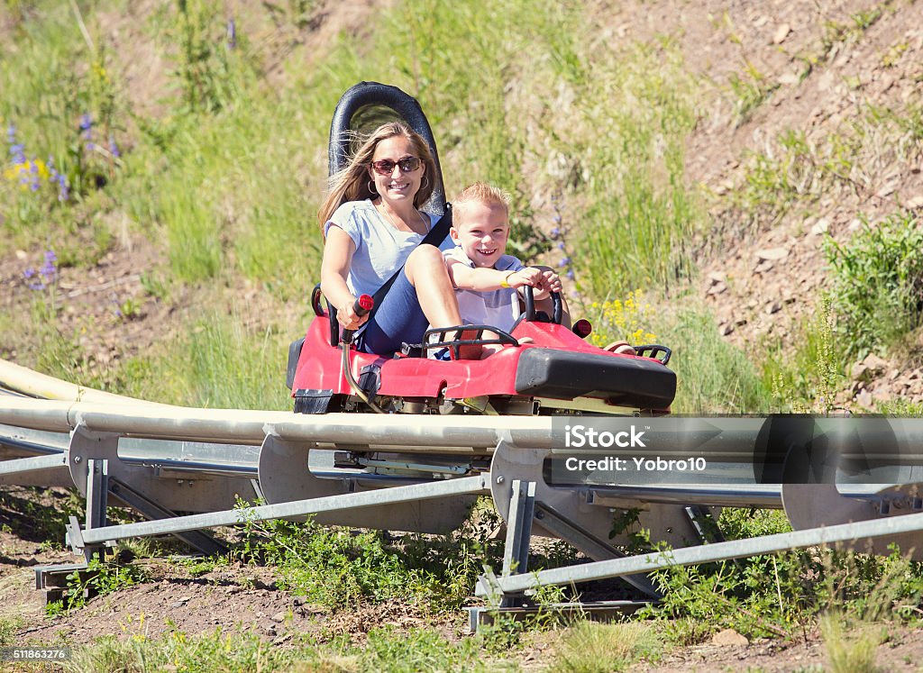 Mother and son on a fun roller coaster ride Ride at an amusement park ride during the summer Park City - Utah Stock Photo