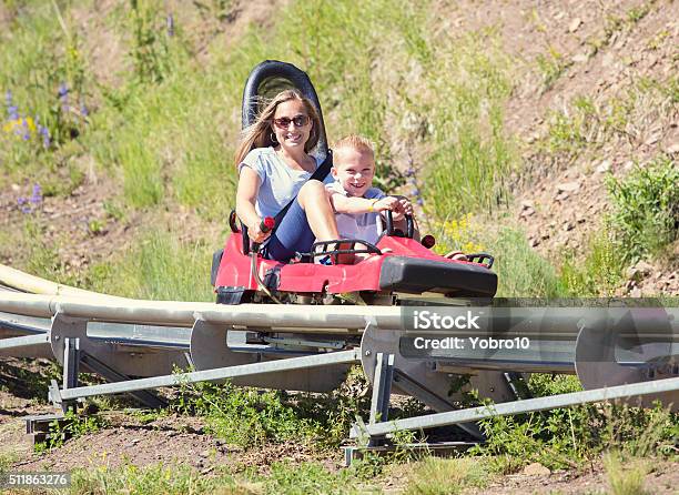 Mother And Son On A Fun Roller Coaster Ride Stock Photo - Download Image Now - Park City - Utah, Slide - Play Equipment, Sliding