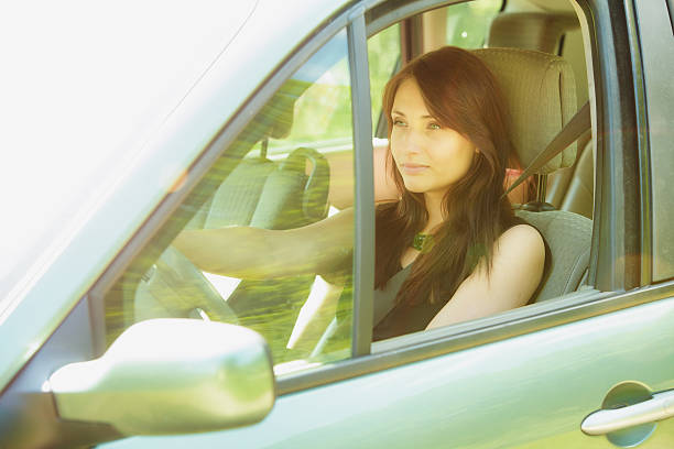 istock Transportation. Brunette woman driving a car 511867189