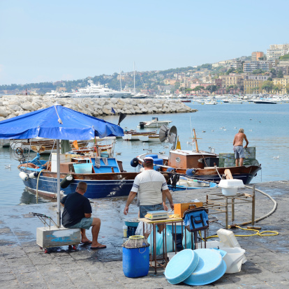 Naples, Italy - September 4, 2014: the last remaining few fishermen still do that every day the historic traditional market of fresh fish on the beach in Naples.