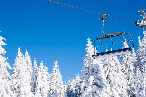 istock Ski resort image with chair lift and white snow pine 511867766