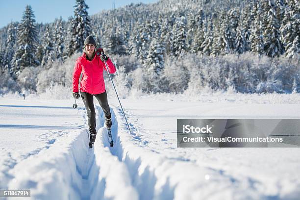 Woman Cross Country Skiing On Sunny Day Stock Photo - Download Image Now - Cross-Country Skiing, Women, Snow