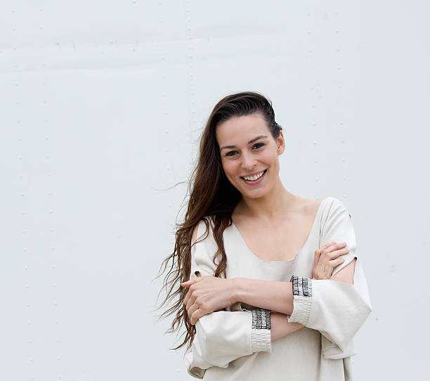 istock Woman smiling with arms crossed 511868279