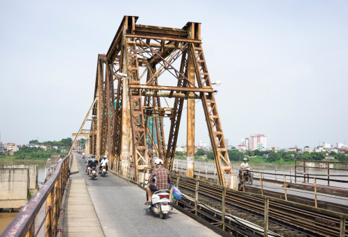 Ha Noi, Viet Nam - September 7, 2014: Vehicle traffic moving on the old railway bridge in Vietnam