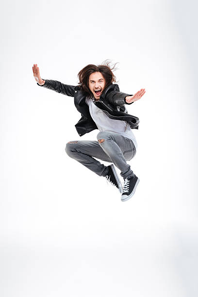 istock Handsome excited young man jumping and screaming 511869000