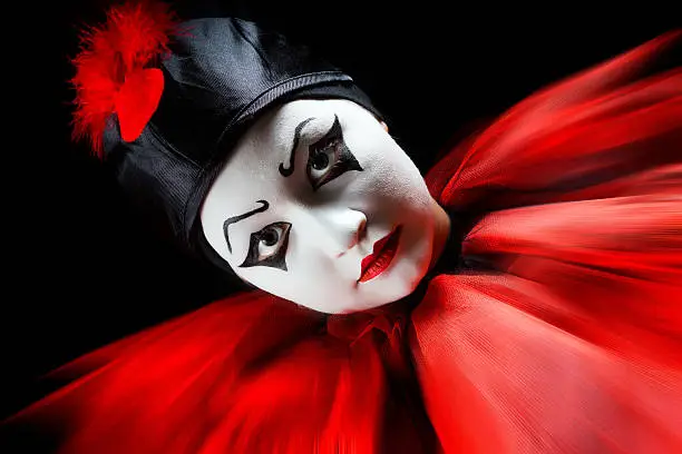 Flashing portrait in red and black of a mime pierrot clown