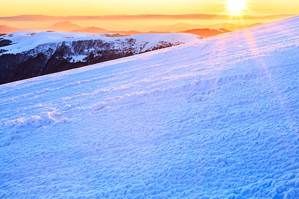 istock Sunset in snowy mountains 511869140