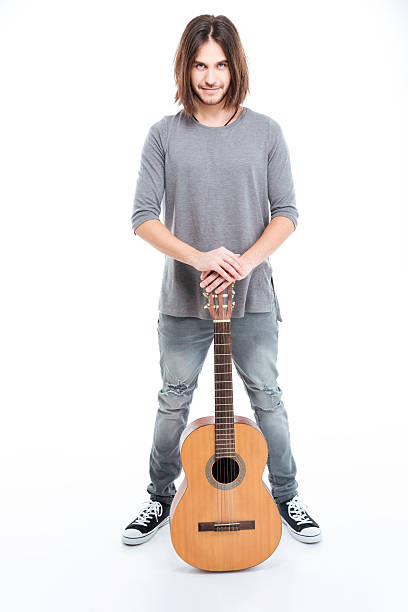 istock Happy confident young man standing with guitar 511869290