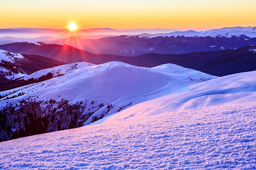 Beautiful rural scene of sunset in snowy Carpathian Mountains