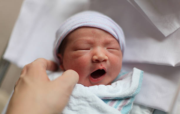 istock Newborn baby reacts to gentle touch. 511869529