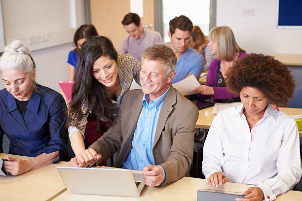 istock Mature Students In Further Education Class With Teacher 511869849