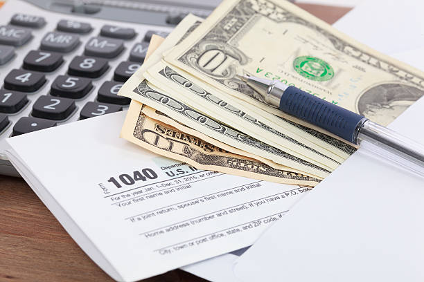 istock Money and calculator with tax form 511870120