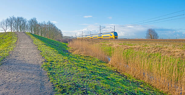istock Electric train riding through nature in winter 511870142