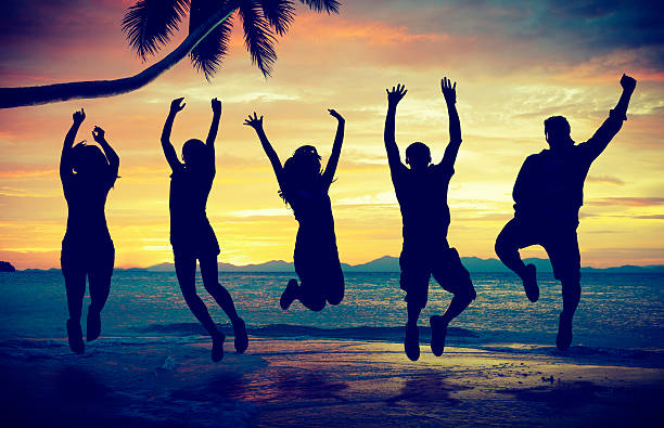 istock Young People Jumping with Excitement on the Beach 511870711