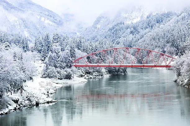 Red Bridge with winter landscape along Tadami River in Fukushima Japan