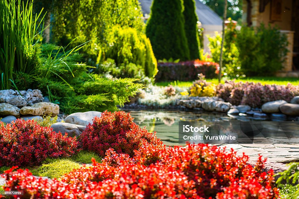 landscape design beautiful landscaping with beautiful plants and flowers Yard - Grounds Stock Photo